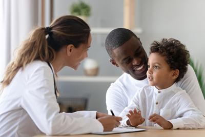 Father and son visiting pediatrician for routine well-child care.
