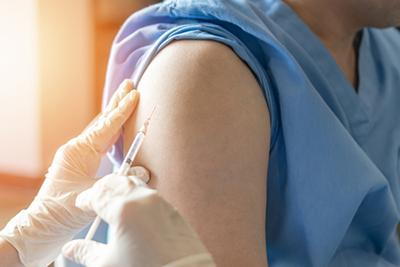Doctor giving an immunization to a patient