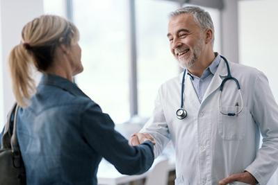 Woman shaking hand to the doctor on clinic