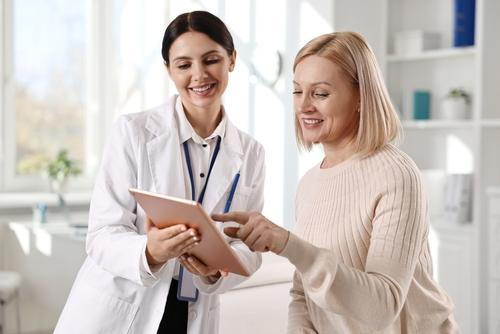 Close-up of a medical professional providing advice and evaluation to a female patient.