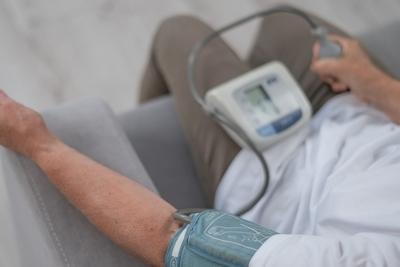 Person using digital monitor to check blood pressure