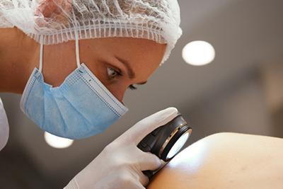 Skin-Doctor-Examines-Patient's-Skin-for-Suspicious-Moles