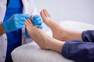 Foot-Doctor-Checking-Patient's-Foot-Health