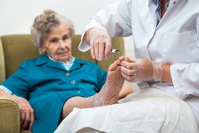 Podiatrist-Visits-Elederly-Woman-at-Home-for-Medical-Pedicure