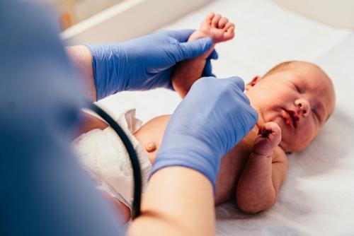 Pediatrician conducting a checkup on a newborn baby