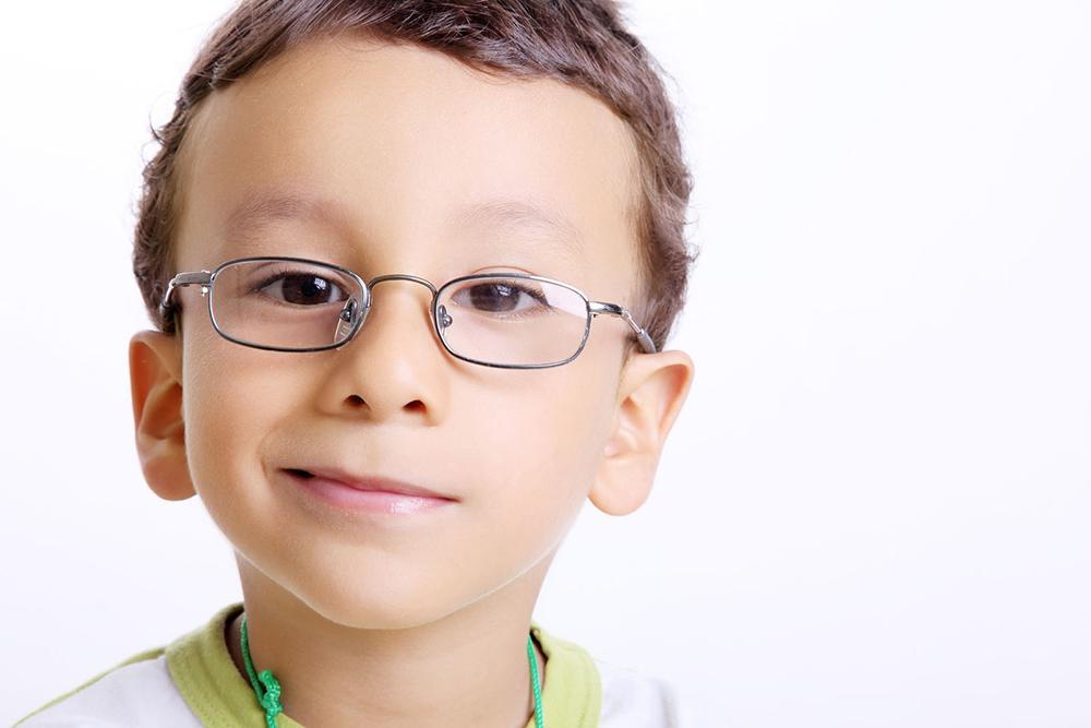 young child wearing new eyeglasses