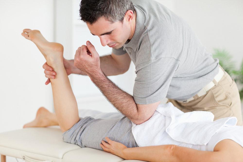 A man massaging a woman's leg