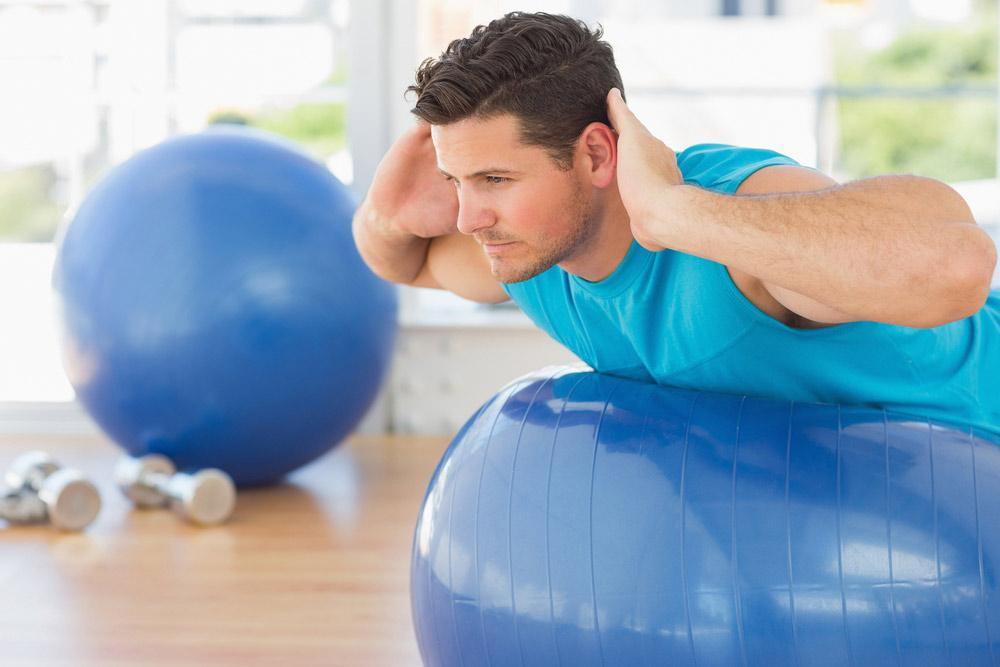 Man Exercise on a fitness ball
