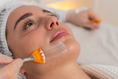 Woman in procedure of chemical peels on clinic.