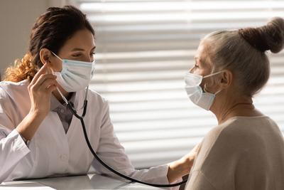 Doctor checking the health of a senior woman on clinic