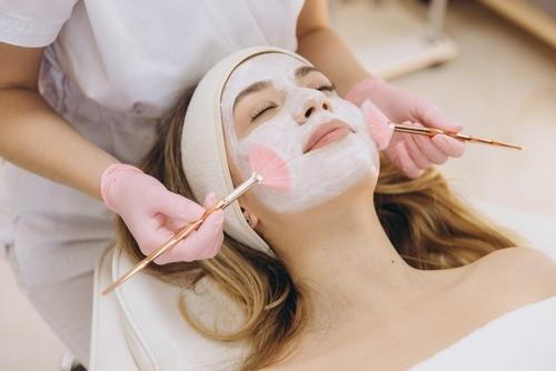 Woman receiving a facial skincare treatment from a dermatologist