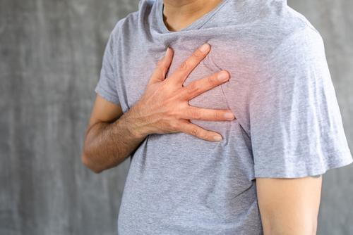 Man clutching chest due to pain