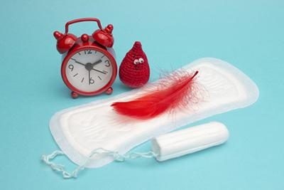 Tampon-and-Pads-with-Red-Feather-Symbolizing-Menstruation