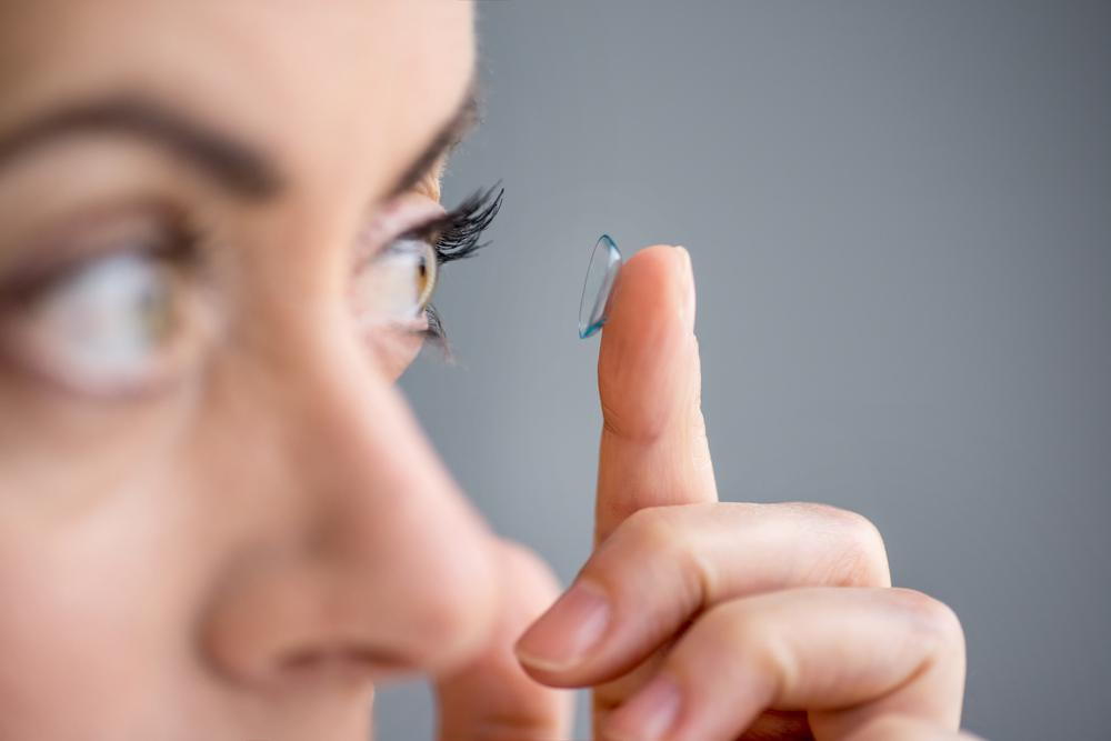 woman putting in a contact lens