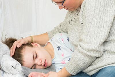 Young woman suffering from seizures with her mother