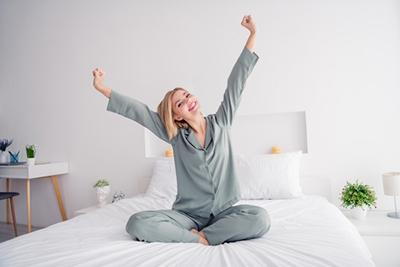 Woman starting her day happy after deep sleep