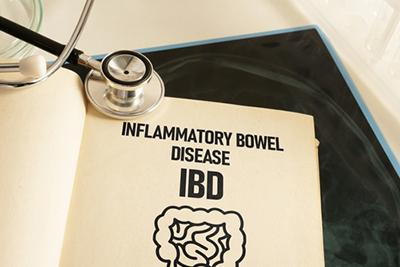 Medical clipboard with IBD information next to stethoscope on desk