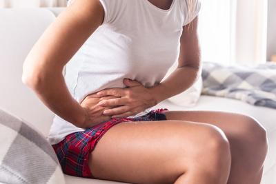 Woman holding her abdomen feeling in pain