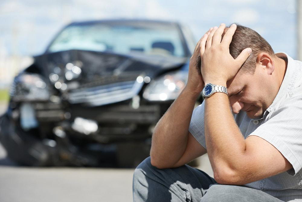 A frustrated male with a car accident