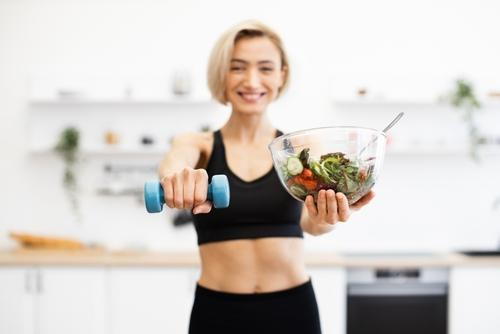 Female demonstrating healthy lifestyle with food and exercise