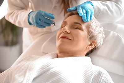 Dermatologist-Injecting-Dermal-fillers-to-Client