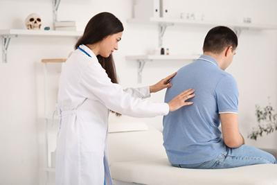 Client's-Bad-Posture-is-Being-Corrected-by-Chiropractor