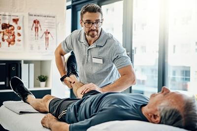 Male patient receiving chiropractic care for knee pain