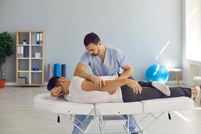 Male-Client-Receiving-Sciatica-Treatment-from-Chiropractor