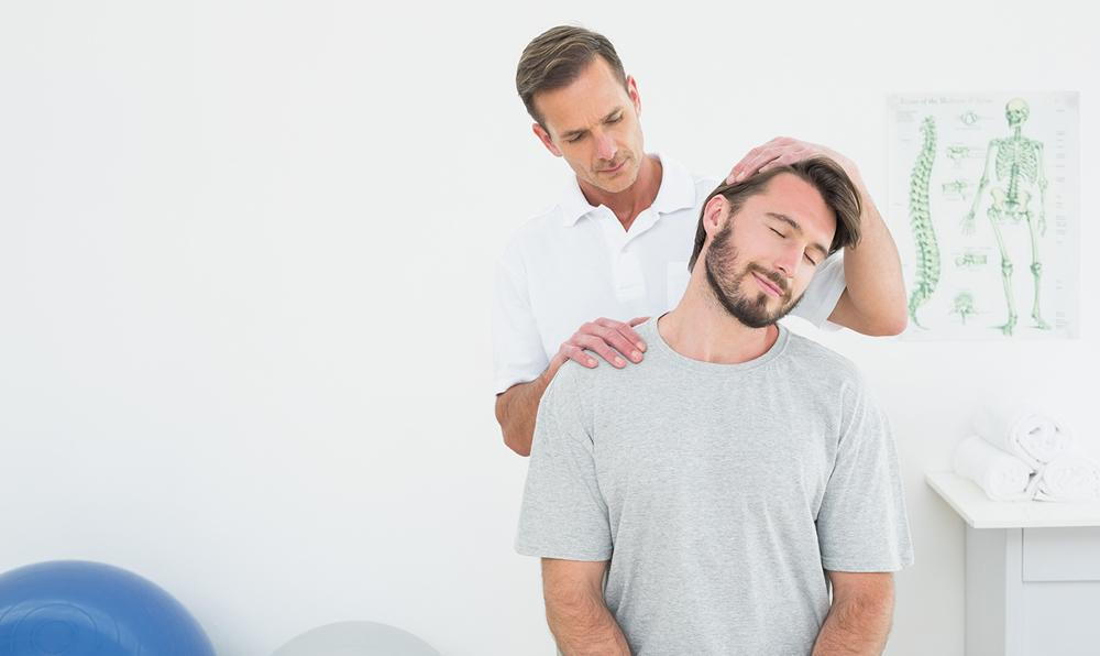 Chiropractor treating patient with neck pain