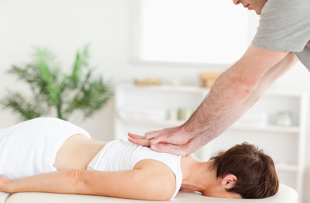 Chiropractor adjusting a patients back