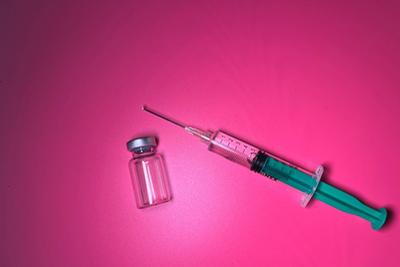 Syringe-and-Capsule-with-pink-background