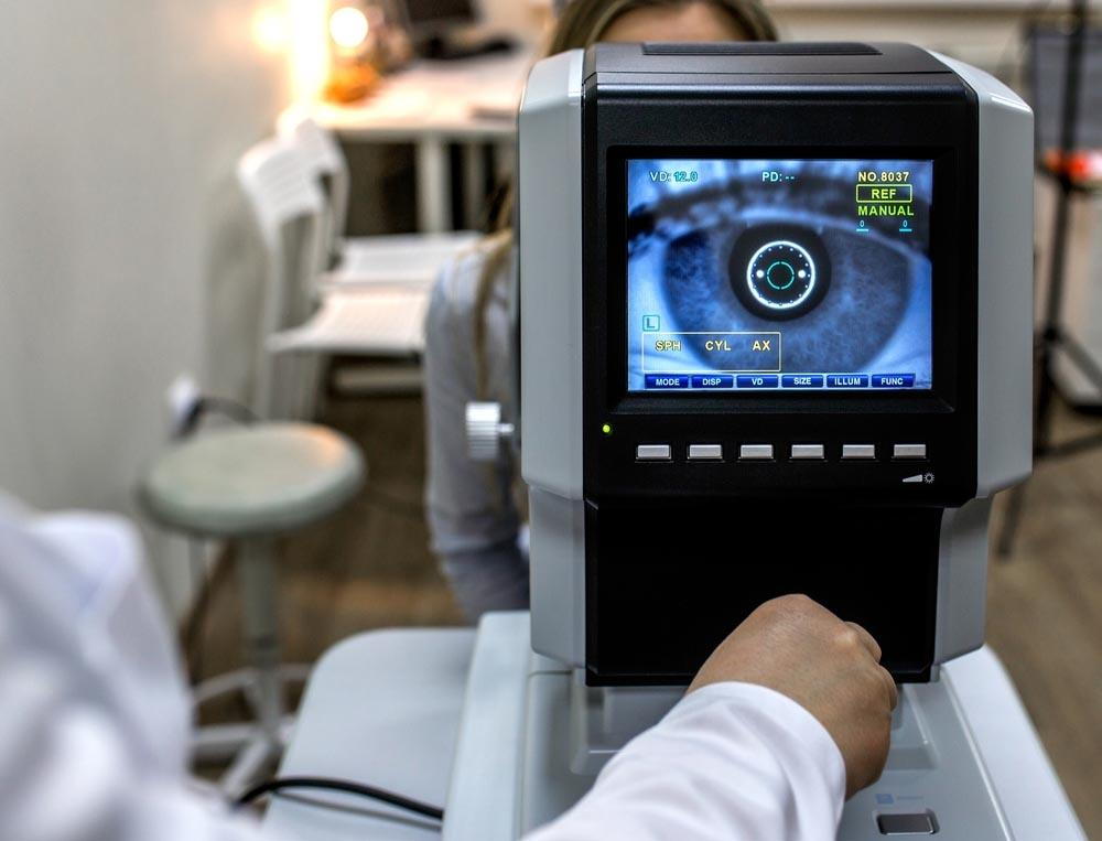 lady looking into an eye machine to get her eyes checked- Is lassik eye surgery in pensacola worth it- Fifty Dollar Eye Guy 5328 N Davis Hwy Pensacola, FL 32503 (850) 434-6387