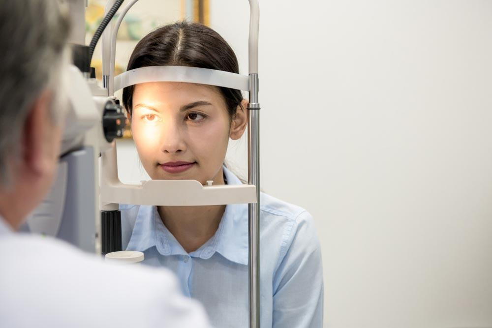 optometrist looking at a women’s eye- What Should I Expect During Lasik Surgery In Pensacola- Fifty Dollar Eye Guy 5328 N Davis Hwy Pensacola, FL 32503 (850) 434-6387