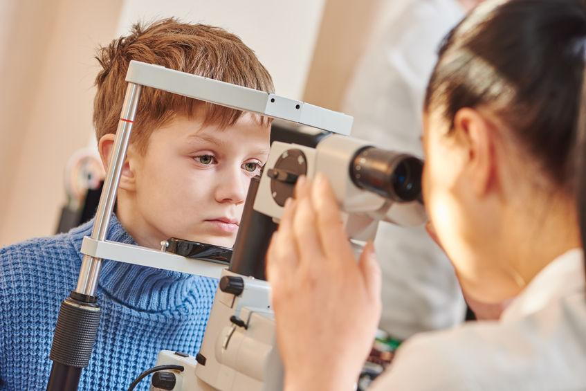 A Boy Getting His Eyes Checked By An Eye Doctor-  Learning More About What Is EyeMed Insurance Pensacola- Fifty Dollar Eye Guy 5328 N Davis Hwy Pensacola, FL 32503 (850) 434-6387