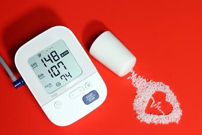 Visual concept showing salt in a heart shape to highlight its impact on hypertension and cardiovascular health.