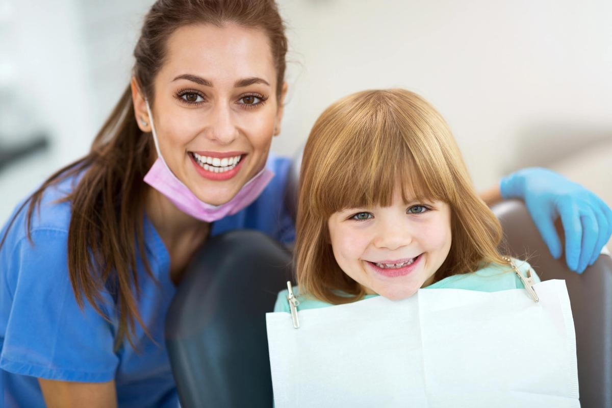 dentist and kid smiling after Children sleep dentistry commack