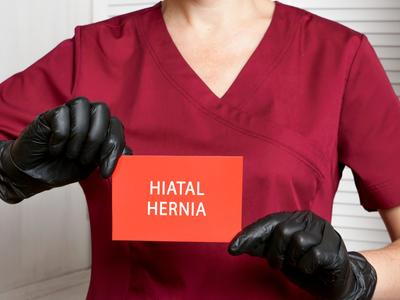 Clinical assistant holding Hiatal Hernia label