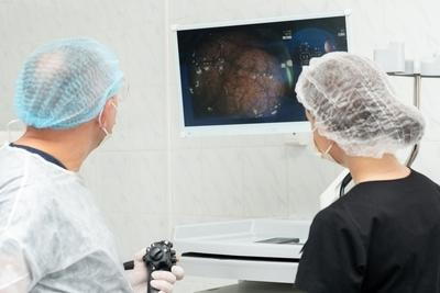 Colonoscopy on patient with the doctor and clinical assistant