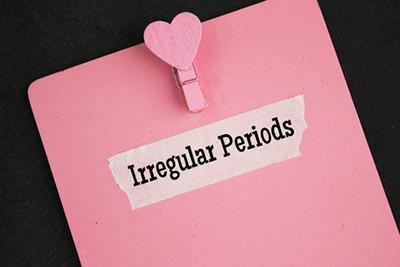 Clipboard displaying printed text about irregular menstrual cycles