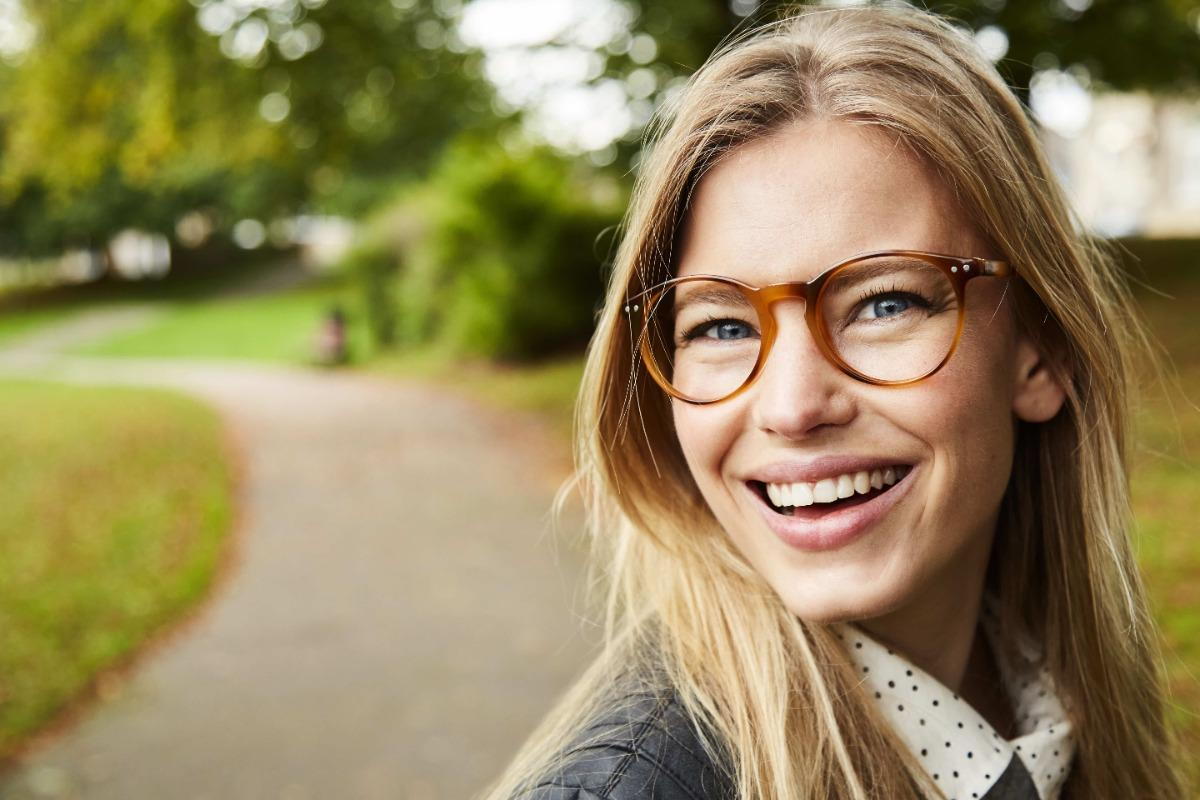 women with glasses smiling.