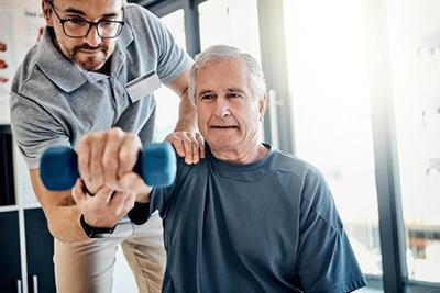Elderly patient undergoing chiropractic physical therapy for joint pain relief.