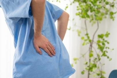 Person suffering in back pain indoor