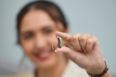 Woman holding an healring aid