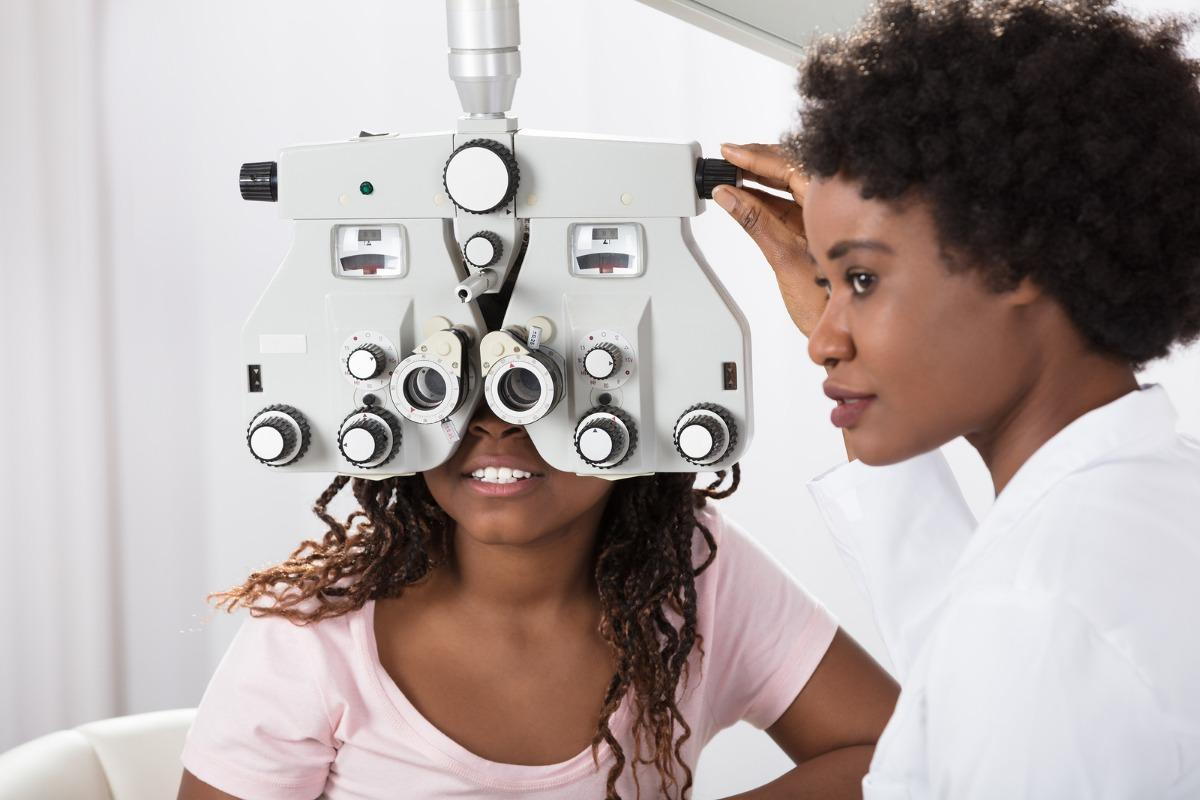 girl getting her eyes checked from her optometrist