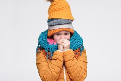 Young girl with fully coat with colds