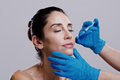 Patient undergoing cosmetic filler procedure to improve fullness in lips and cheeks