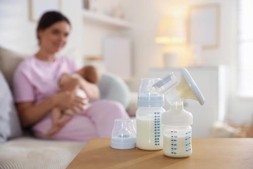 Milk bottles with mother and baby in the background
