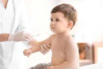 Toddler giving a vaccination by the doctor