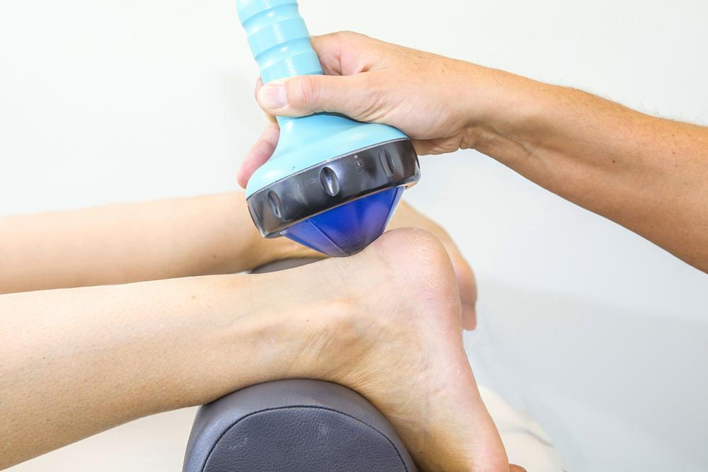 Patient getting shockwave therapy treatment for plantar fasciitis