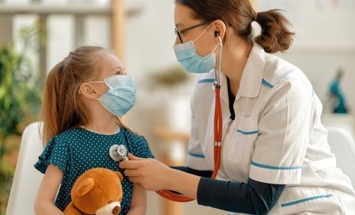 Pediatrician treating child with flu symptoms
